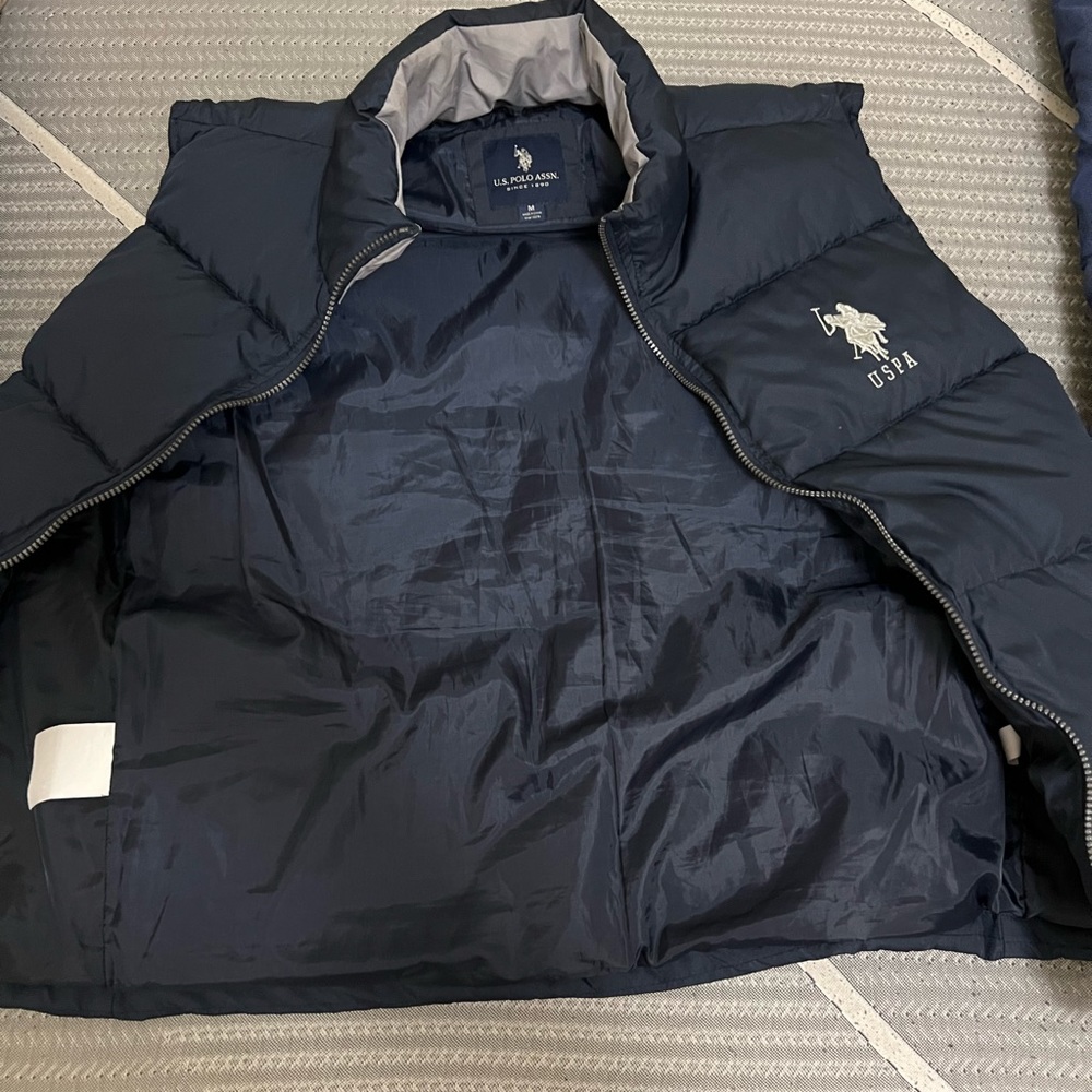 Navy blue sleeveless polo coat